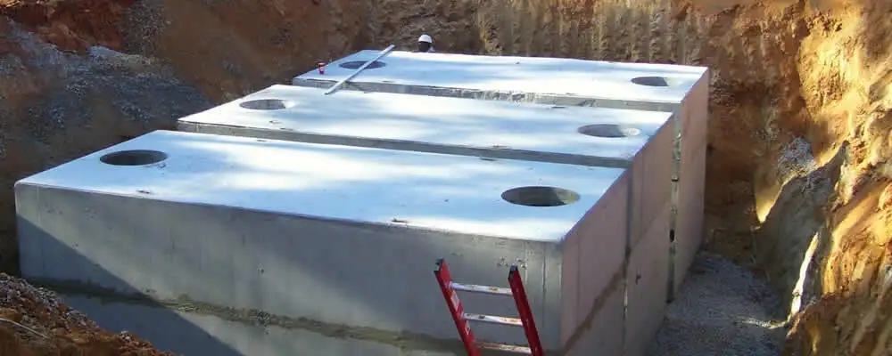 Septic tank installation site with a newly placed concrete tank in Reading, MA